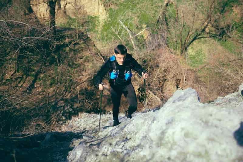 hiking up steep mountain in moisture wicking shirt
